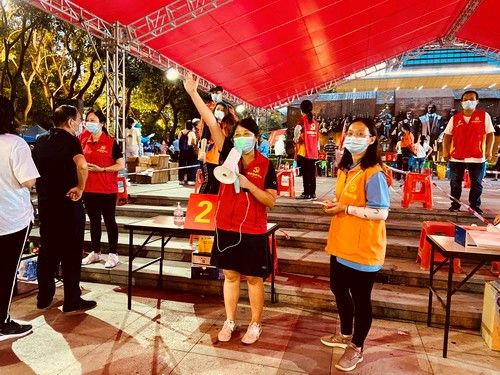 社區(qū)僑聯(lián)干部陳文靜在興中園核酸檢測點合理安排居民群眾排隊，叮囑保持“一米線”，準(zhǔn)備好身份證和核酸碼，